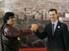 File-- In this March 2008 file photo, Libyan leader Moammar Gadhafi , left, gestures with Syrian President Bashar Assad, right, during the opening session of the Arab Summit in Damascus, Syria. When Bashar Assad inherited power in Syria in 2000, he was seen by many as a youthful new president in a region of aging dictators, a fresh face who could transform his father's stagnant dictatorship into a modern state. Now this once-popular image of Assad, as a reformer constrained by members of his late father's old guard, has vanished in the aftermath of one of the bloodiest government backlashes of the Arab Spring. (AP Photo/Hussein Malla, file)