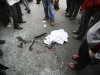 EDS NOTE: GRAPHIC CONTENT - In this photo provided by the semi-official Fars News Agency, people gather around shattered glass and human remains in Tehran, Iran, Wednesday, Jan. 11, 2012. Two assailants on a motorcycle attached magnetic bombs to the car of an Iranian university professor working at a key nuclear facility, killing him and wounding two people on Wednesday, a semiofficial news agency reported. (AP Photo/Fars News Agency, Mehdi Marizad)