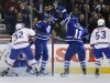 Toronto Maple Leafs' McLaren celebrates goal with McClement in front of Montreal Canadiens' Moen and White during NHL hockey game in Toronto