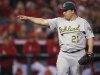 Oakland Athletics starting pitcher Bartolo Colon celebrates the last out against the Los Angeles Angels in the eighth inning of a baseball game in Anaheim, Calif., Wednesday, April 18, 2012. (AP Photo/Chris Carlson)
