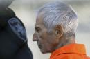FILE - In this Tuesday, March 17, 2015, file photo, Robert Durst is escorted into Orleans Parish Prison after his arraignment in Orleans Parish Criminal District Court in New Orleans. The whispered words of Durst recorded in an unguarded moment in a bathroom could come back to haunt him - or help him - as he faces a murder charge. A possible move by prosecutors to introduce the incriminating material from a six-part documentary on his strange life and connection to three killings could back fire as interview footage did in the Michael Jackson molestation trial and the Robert Blake murder case. (AP Photo/Gerald Herbert, File)