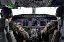 Lieutenant Hunt and Lieutenant (junior grade) Horton, naval aviators assigned to Patrol Squadron (VP) 16, pilot a P-8A Poseidon during a mission to assist in search and rescue operations for Malaysia Airlines flight MH370
