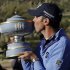 Matt Kuchar kisses the Walter Hagen Cup after defeating Hunter Mahan 2 and 1 in the final round of play during the Match Play Championship golf tournament, Sunday, Feb. 24, 2013, in Marana, Ariz. (AP Photo/Ted S. Warren)