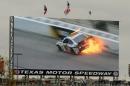 A video screen shows a replay of Dale Earnhardt Jr.'s (88) car during a wreck at the NASCAR Sprint Cup series auto race at Texas Motor Speedway, Monday, April 7, 2014, in Fort Worth, Texas. (AP Photo/Larry Papke)