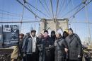 From left, Brooklyn borough president Eric Adams, Civil rights attorney Norman Siegel, New York City Councilman Jermaine Williams, Dr. Karen Daughtry, and Senator Jesse Hamilton (D-NY), march over the Brooklyn Bridge to mark the 50th anniversary of the landmark event of the civil rights movement in Selma, Ala., on Saturday, March 7, 2015, in New York. Fifty years ago marchers crossing a bridge in Selma for a voting rights demonstration were beaten by police in a confrontation called "Bloody Sunday."(AP Photo/John Minchillo)