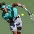 Nadal of Spain returns a volley at the net against Berdych of the Czech Republic during their men's singles semifinal match at the BNP Paribas Open ATP tennis tournament in Indian Wells
