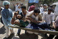 Yemeni anti-government protestors carry an injured protestor from the site of clashes with security forces, in Sanaa, Yemen, Tuesday, Sept. 20, 2011. Rapidly escalating street battles between opponents of Yemen's regime and forces loyal to its embattled president spread to the home districts of senior government figures and other highly sensitive areas of the capital on Tuesday. A third day of fighting, including a mortar attack on unarmed protesters, killed nine people, medical officials said.(AP Photo/Hani Mohammed)