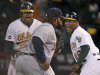 Oakland's Coco Crisp and first base coach Tye Waller celebrate Crisp's game winning RBI against Detroit in the 9th inning