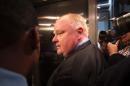 Toronto Mayor Rob Ford is surrounded by the media as he waits for an elevator outside his office at Toronto City Hall on November 15, 2013 in Toronto, Ontario