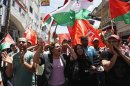 Palestinians wave Palestinian and PFLP flags during protest against renewal stalled peace talks with Israel, in Ramallah