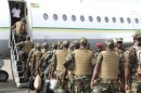 Togolese Army soldiers enter a plane to leave for deployment to Mali, from Togo's capital Lome