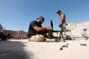 Fighter from forces aligned with Libya's new unity government prepare their weapons in the Zaafran area in Sirte