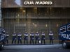 File - In this May 14, 2012 file photo, riot police stand guard in front of a branch of the recently nationalized Caja de Madrid/Bankia bank during a protest in Madrid. Spain could ask for a European rescue of its troubled banks this Saturday June 9, 2012 when European finance ministers hold an emergency conference call to discuss the nation's hurting lending sector, a move that would turn the nation into the fourth from the 17-nation eurozone to seek outside help since the continent's financial crisis erupted two years ago. (AP Photo/Alberto Di Lolli, File)