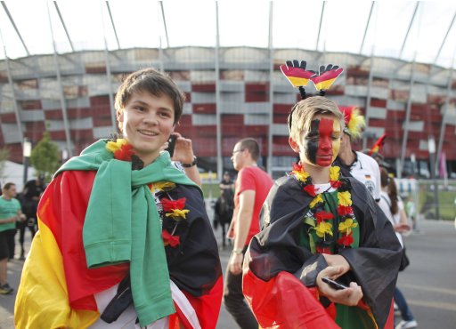Germany soccer fans pose in front of the National stadium in Warsaw