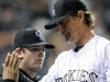 Colorado Rockies starting pitcher Jamie Moyer is congratulated by teammates in the sixth inning of a baseball game against the San Diego Padres on Tuesday, April 17, 2012 in Denver. The Rockies won 5-3. Jamie Moyer became the oldest pitcher to win a major league game. (AP Photo/Chris Schneider)