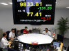 Money traders work under a currency rate indicator showing the yen-dollar exchange rate, bottom, and Nikkei 225 stock average, top,   at a money market brokerage company,  in Tokyo,  Tuesday, Aug. 2, 2011.  Asian stock markets slid Tuesday after downbeat U.S. data fueled fears the world's largest economy might be sliding back into recession.  (AP Photo/Shuji Kajiyama)