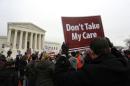 Demonstrators in favor of Obamacare gather at the Supreme Court building in Washington