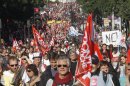 Demonstrators march during a rally with banners and flags to protest against the austerity measures announced by the French government, in Paris, Sunday, Sept 30, 2012. (AP Photo/Michel Euler)