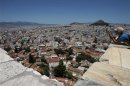 A tourist takes photographs at the Acropolis hill overlooking Athen