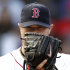 Boston Red Sox starting pitcher Jon Lester peers over his glove at a base runner during the first inning of a baseball game against the Tampa Bay Rays at Fenway Park in Boston, Saturday, Sept. 17, 2011. (AP Photo/Winslow Townson)