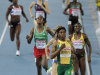 South Africa's Caster Semenya, center, goes to cross the finish line to win a Women's 800m semifinal ahead of Ethiopia's Fantu Magiso, center left, and Jamaica's Kenia Sinclair, right, at the World Athletics Championships in Daegu, South Korea, Friday, Sept. 2, 2011. (AP Photo/Martin Meissner)