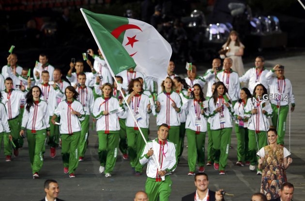 Algeria's flag bearer Abdelhafid Benchabla holds national flag in athletes parade during opening ceremony of London 2012 Olympic Games at Olympic Stadium