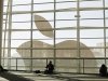Attendees sit in front of an Apple logo during the Apple Worldwide Developers Conference 2012 in San Francisco