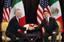 U.S. Vice President Joe Biden, left, shakes hands with Enrique Pena Nieto, former governor of the State of Mexico and current presidential candidate for the Institutional Revolutionary Party, PRI, Mexico City, Monday, March 5, 2012. Biden is on a one-day official visit to Mexico. (AP Photo/Alexandre Meneghini)