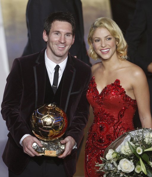 Messi of Argentina, FIFA World Player of the Year holds his FIFA Ballon d'Or 2011 trophy next to singer Shakira during the FIFA Ballon d'Or 2011 soccer awards ceremony in Zurich