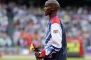 Britain's Mo Farah reacts after being presented with the gold medal in the men's 10,000 meters during the athletics in the Olympic Stadium at the 2012 Summer Olympics, London, Sunday, Aug. 5, 2012. (AP Photo/Luca Bruno)