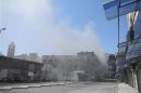 Smoke rises from downtown Homs