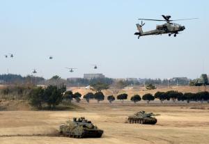 Japanese helicopters fly over tanks during military …