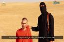 An image grab taken from a video released by the Islamic State and identified by private terrorism monitor SITE Intelligence Group on September 2, 2014 purportedly shows footage of a masked militant and British hostage David Haines