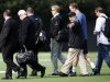 NFL quarterback Peyton Manning, second from right at rear, walks across a football practice field with Denver Broncos executive John Elway, fourth from left, near Wallace Wade Stadium, Friday, March 16, 2012, at Duke University in Durham, N.C. Elway and coach John Fox watched the star quarterback throw at Duke's athletic fields. (AP Photo/The News & Observer, Travis Long)