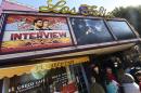 Movie-goers wait in line outside the Los Feliz 3 Cinema in Los Angeles, California on December 25, 2014 to purchase tickets for the "The Interview"