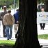 Google workers walk outside of Google headquarters in Mountain View, Calif., Thursday, April 12, 2012. Google Inc. said Thursday that it earned $2.89 billion, or $8.75 per share, in the first quarter. That’s up from $1.8 billion, or $5.51 per share, a year earlier. (AP Photo/Paul Sakuma)