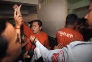 A man convicted of plotting to overthrow the Cambodian government shouts after being sentenced at the Phnom Penh Municipal Court