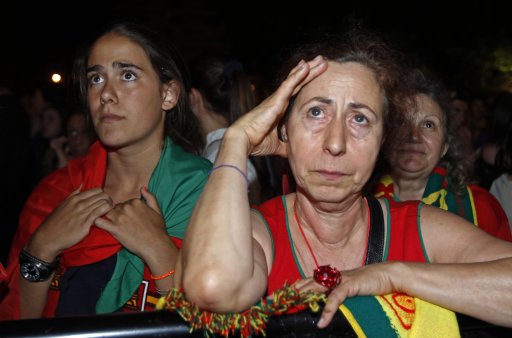 Portuguese soccer fans react at the end of the semi final Euro 2012 soccer match between the Portugal and Spain at a public screening in Lisbon