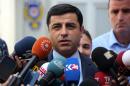 Pro-Kurdish Peoples' Democracy Party leader Selahattin Demirtas speaks to the media about Turkey's airstrikes against Kurdish rebel bases in Iraq, in Ankara, Turkey, Monday, July 27, 2015. Turkey's unexpected move to launch simultaneous air raids not only against the Islamic State group but also Kurdish rebels risks ending of a period of relative calm that has been boon for Turkey's democracy and economy. (AP Photo)