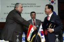 Vice President Jung Jin-seok, right, shakes hand with Hashim Abdul-Ghafour,General Director of state-run Pipelines Company , left, in Baghdad, Iraq, Tuesday, Oct. 23, 2012. Iraq on Tuesday inked a multi-million dollar deal with South Korea's KOGAS that will set in motion the building of two key gas pipelines in the country's north .(AP Photo/Hadi Mizban)