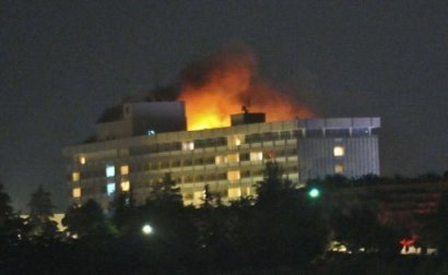 Smoke and flames light up the night from a blaze at the InterContinental hotel after an attack on the hotel by Taliban fighters in Kabul. Heavily armed Taliban militants stormed a top the hotel, sparking a ferocious battle involving Afghan commandos and a NATO helicopter gunship that left at least 21 dead including the nine attackers