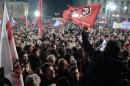 Anti-austerity Syriza supporters celebrate as they gather at the Syriza election kiosk in Athens on January 25, 2015