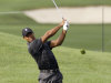 Tiger Woods hits to the ninth green during practice for the Bridgestone Invitational golf tournament at Firestone Country Club in Akron, Ohio Tuesday, Aug. 2, 2011. (AP Photo/Mark Duncan)