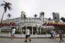 People walk past Hotel El Caribe in Cartagena, Colombia, Saturday April 14, 2012. The Secret Service sent home some of its agents for misconduct that occurred at the hotel before President Barack Obama's arrival on Friday for the Summit of the Americas. (AP Photo/Fernando Vergara)