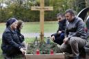 Zammo Marza, Sherineh Marza, Charli Kanoun and Abdo Marza, from left, kneel at the grave of Marza Marza in Saarlouis, Germany in this Monday, Nov. 7, 2016 photo. The Marza family were among 226 Assyrian Christians taken captive by the Islamic State group in a February 2015 attack on their villages in Syria's Khabur River valley. It took a year to free the hostages, and only after three were killed and millions of dollars gathered by the Assyrian diaspora worldwide was paid to the militants, and in the end the Khabur region has been totally emptied of the tiny, centuries-old minority community. (AP Photo/Michael Probst)