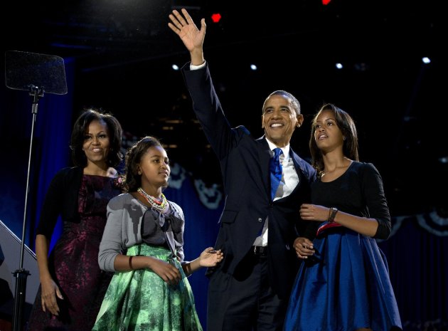 President Barack Obama waves as he walks on stage with first lady Michelle Obama and daughters Malia and Sasha at his election night party Wednesday, Nov. 7, 2012, in Chicago. Obama defeated Republica