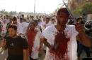 Iraq Shi'ite Muslim men bleed as they gash their foreheads with swords and beat themselves while commemorating Ashura in Baghdad