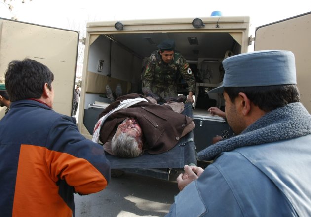 Afghans help transport a wounded man on a stretcher from an ambulance outside a hospital, after a suicide attack at a Shi'ite Muslim gathering in Kabul