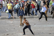 Protesters hurl stones during clashes between supporters and opponents of President   Mohammed Morsi in Alexandria, Egypt, Friday, Nov. 23, 2012. Opponents and supporters of
 Mohammed Morsi clashed across Egypt on Friday, the day after the president granted himself sweeping new powers that critics fear can allow him to be a virtual dictator. Thousands from the two camps threw stones and chunks of marble at each other outside a mosque in the Mediterranean city of Alexandria after Friday Muslim prayers.(AP Photo/Tarek Fawzy)