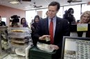 Republican presidential candidate, former Pennsylvania Sen. Rick Santorum, insists on paying for his lunch, Saturday, March 3, 2012, in Wilmington, Ohio. (AP Photo/Eric Gay)